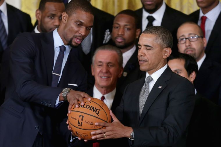 Chris Bosh hands POTUS a basketball with the signatures of the team at The Heat’s visit to the White House.