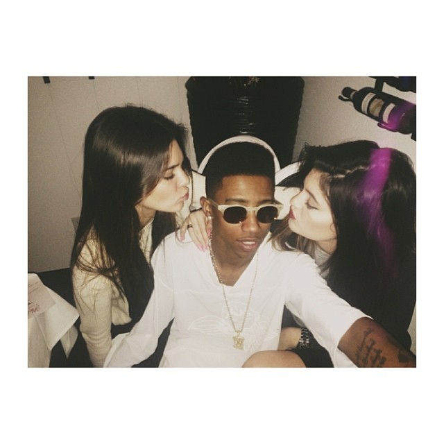 Kylie and Kendall Jenner give the birthday boy a kiss.