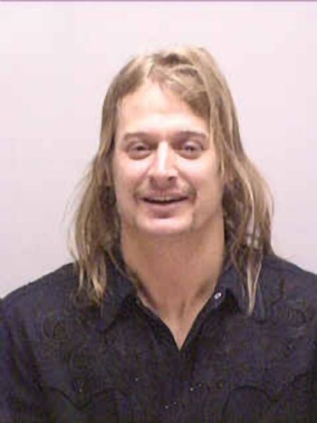 Kid Rock laughed as he was arrested by police after allegedly punching a DJ at a strip club in 2005.
