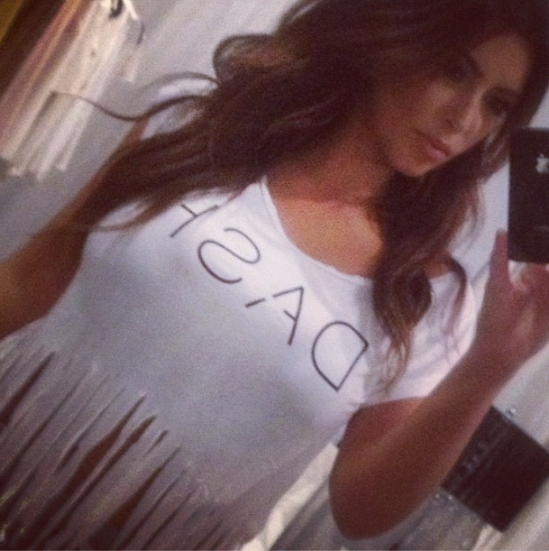 Kim wears a ‘Dash’ shirt as she snaps away..