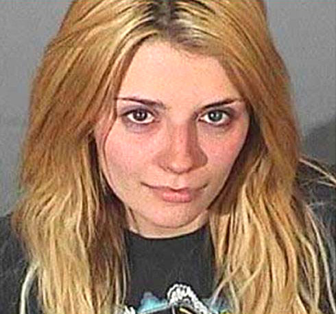 Mischa Barton manages a wry smile for her police mugshot after being arrested for DUI in 2007.