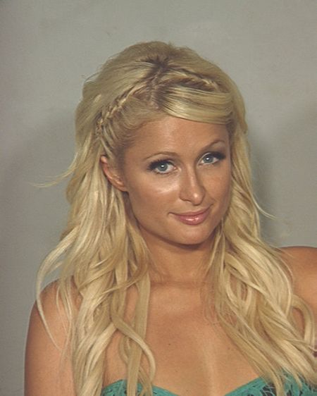 Paris Hilton smiling for her 2010 police mugshot after she was arrested in Las Vegas for allegedly possessing cocaine.