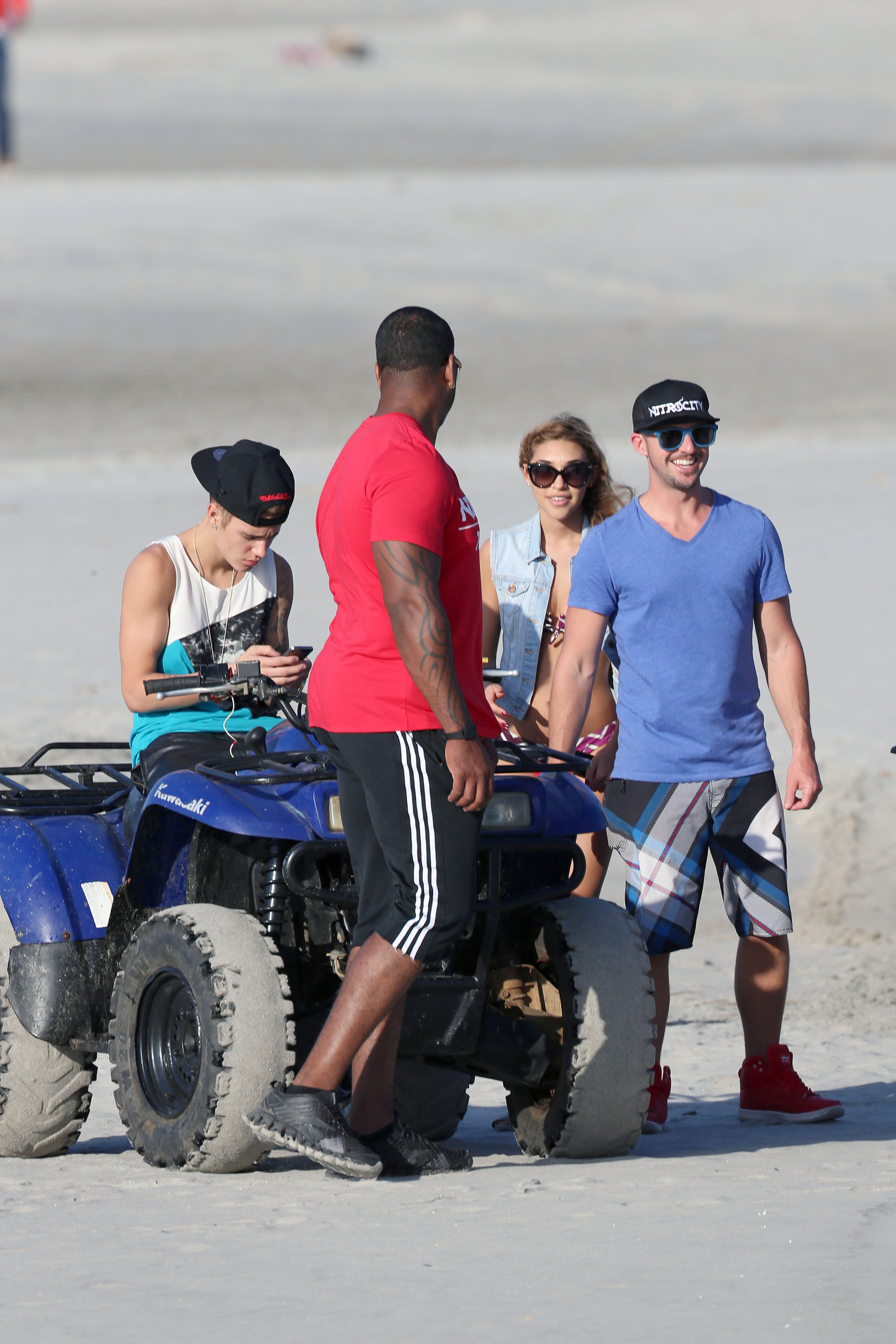 Justin Bieber takes to a Panamanian beach on an ATV watched by Chantel Jeffries
