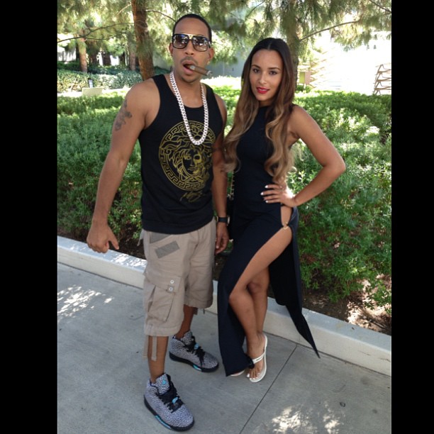 Luda and his girl Eudoxie swag it out at a Vegas pool party.