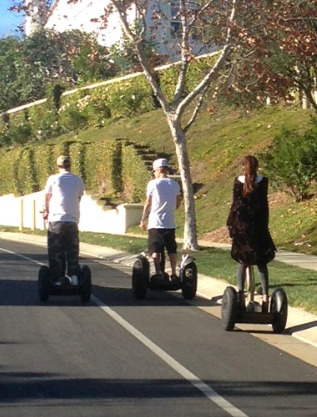 Biebs and Selena have some young fun on Segways.