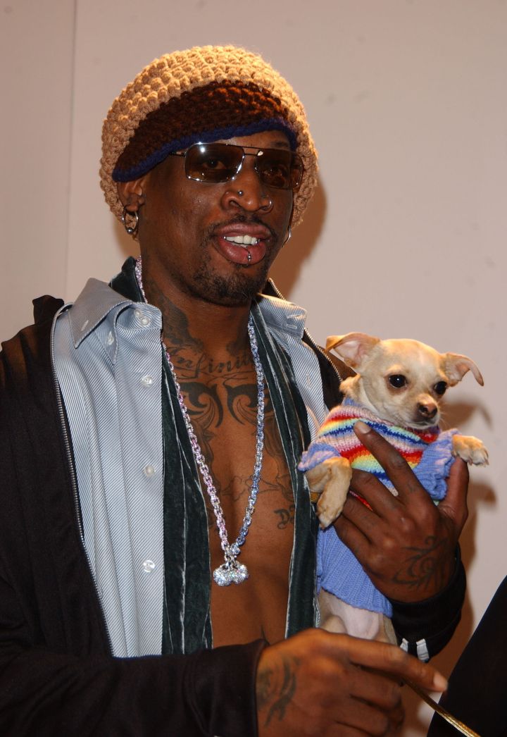 Dennis Rodman chilling with Lucy Anne the chihuahua.