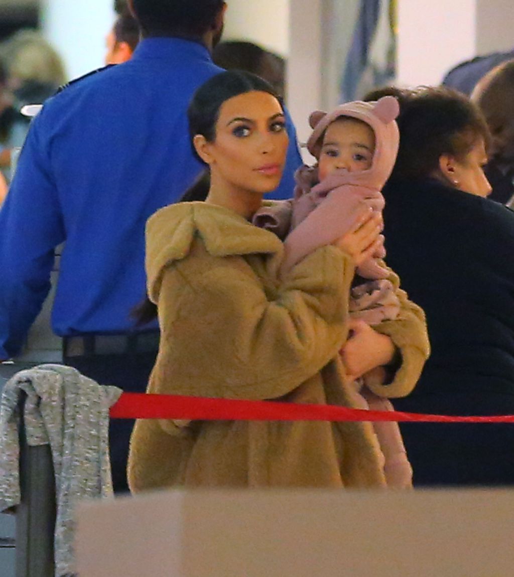Kim Kardashian holds baby North West while wearing a fur coat NYC