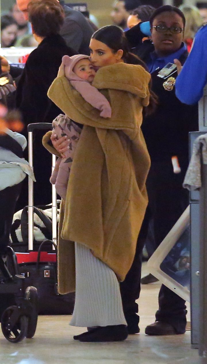 Kim Kardashian snuggled up close to her baby girl, Nori, while wearing a fur coat in NYC.