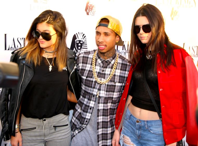 Kendall and Kylie on Tyga’s arm before Kylie went punk rock pretty.