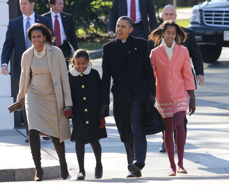 The Obamas bundle up for Sunday mass.