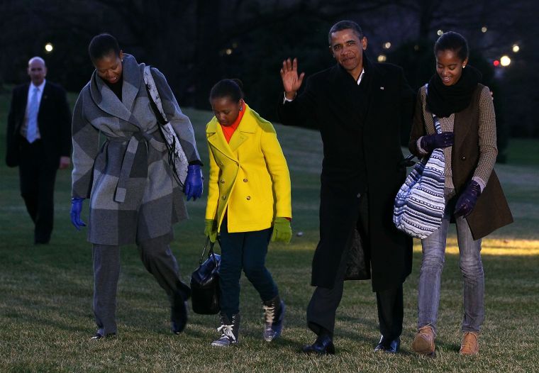 The First Family returns from vacation in their winter wear.