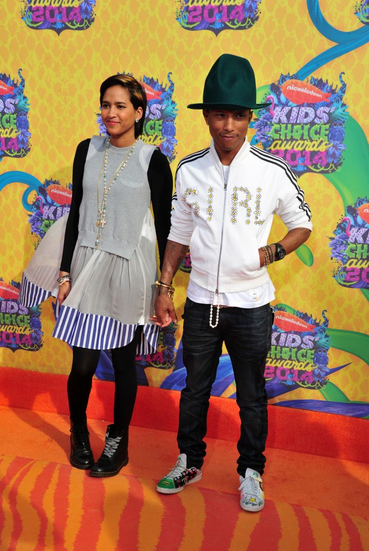 Pharrell and his hat in a custom Adidas firebird jacket with wife Helen