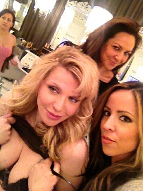 Courtney Love looking super fab with her own glam-squad. But for some reason lifting her shirt?