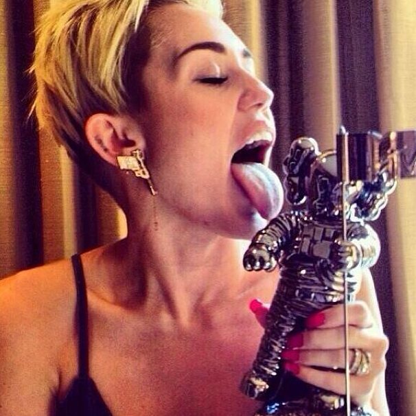 Miley Cyrus licking her MTV Moonman.