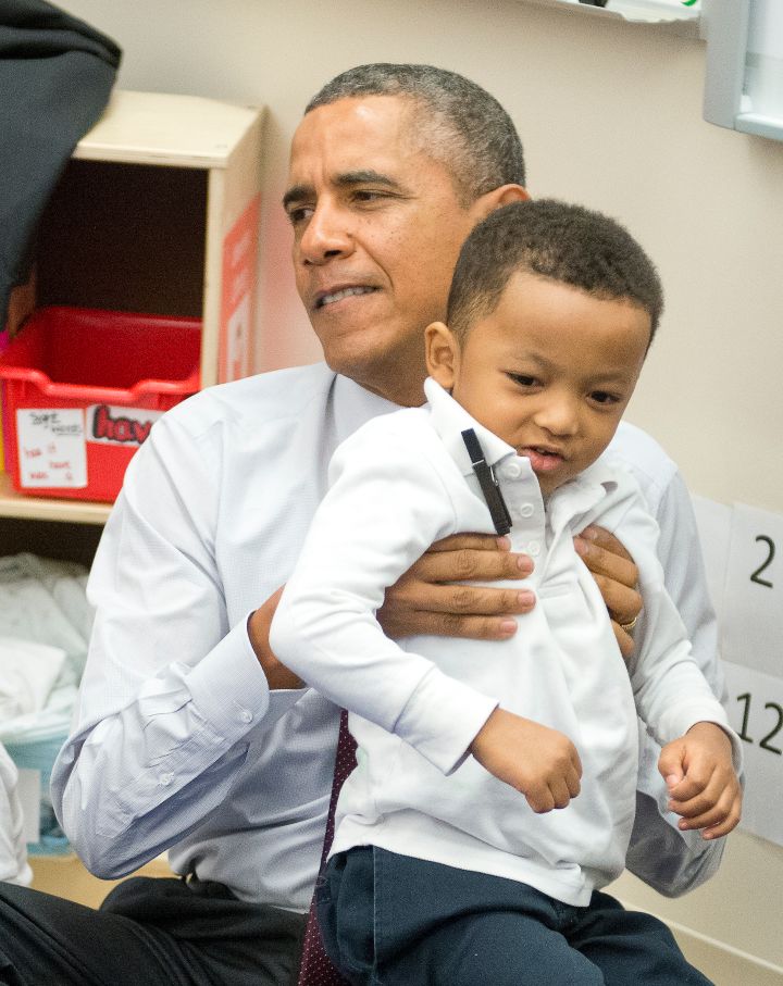 Obama loves the kids…even when they’re a chore to pick up.