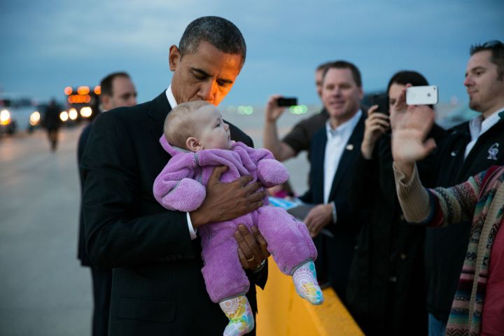 The president takes the time to greet Americans and a cute baby on an airplane tarmac.
