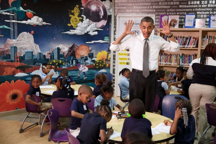 President Obama gives an animated expression while meeting with students at an elementary school.