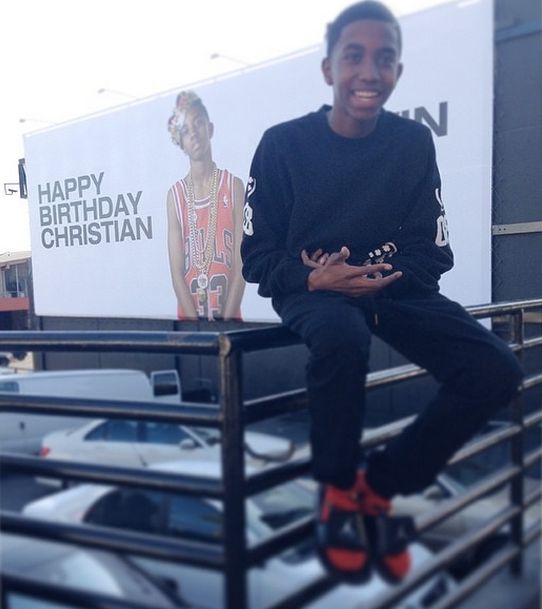 Christian Combs in front of his birthday billboard