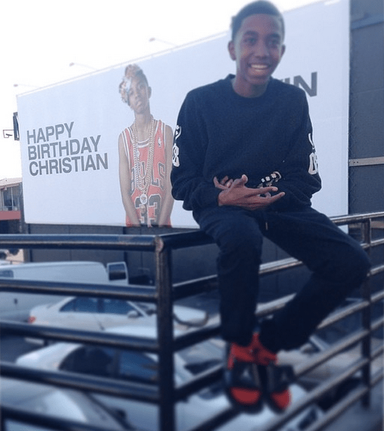 Christian Combs in front of his birthday billboard