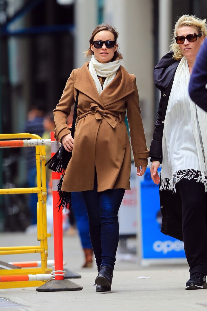 Pregnant Olivia Wilde was wrapped in a sexy camel coat as she goes for a walk in New York City.