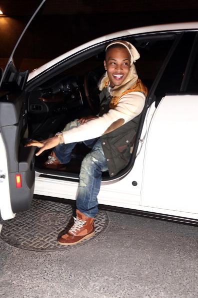 T.I. stepping out of his car.