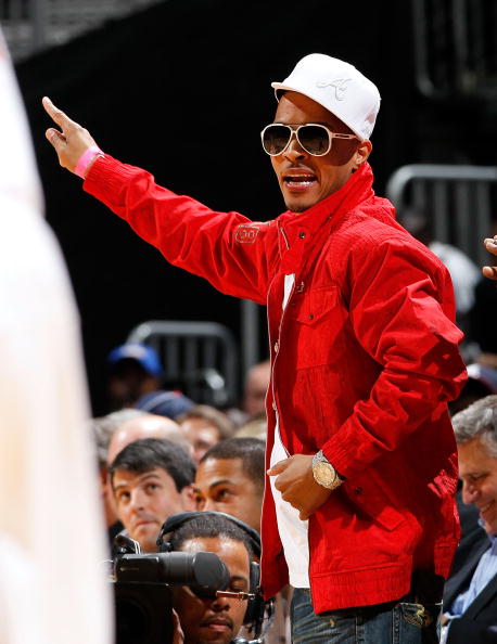 T.I. wearing an all-white Atlanta fitted.