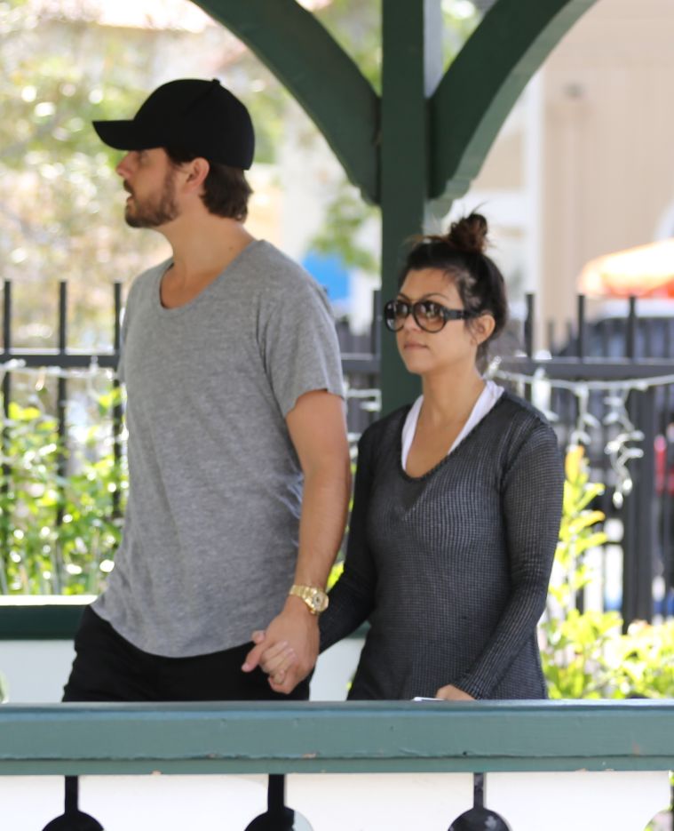 Scott and Kourtney holding hands.