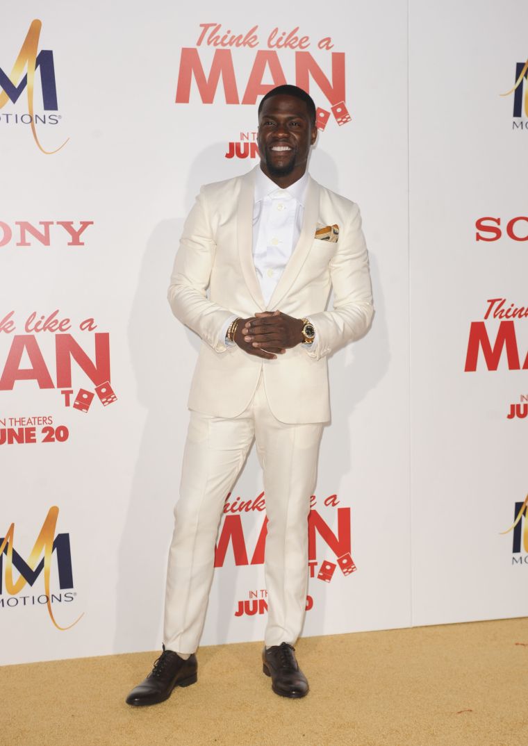 Kevin Hart opted for a cream-colored suit and an air tie.