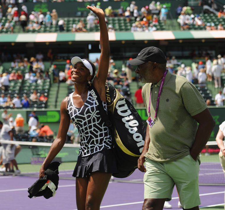 Venus waves to her peeps in 2012 with her dad.