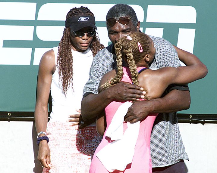Serena hugs her dad in Belgium as Venus watches on in 2001.