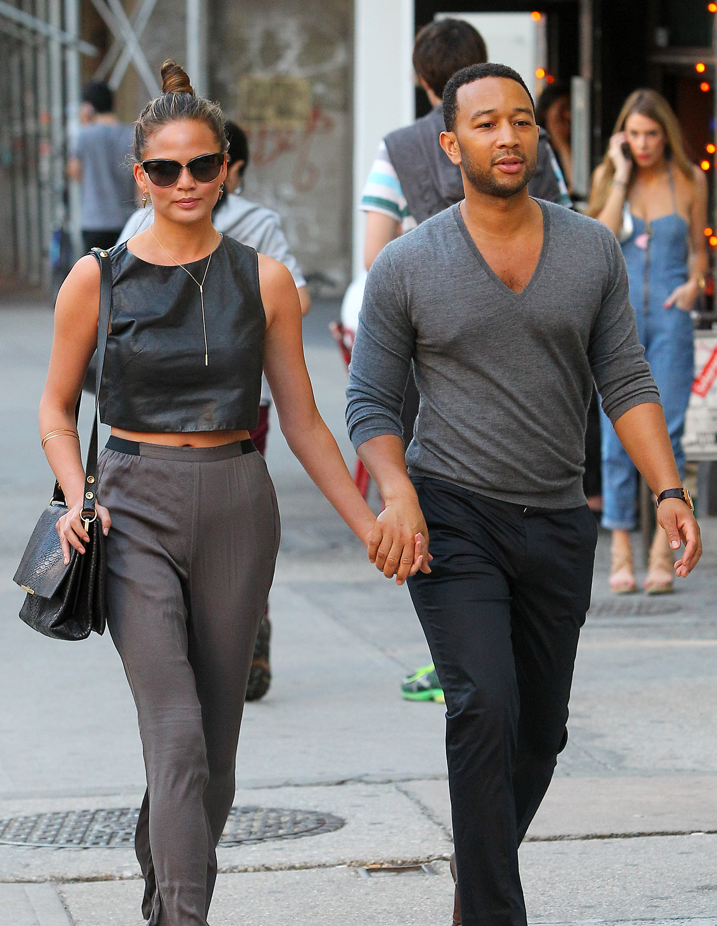 Chrissy Teigen and John Legend hold hands as they make their way to dinner in NYC