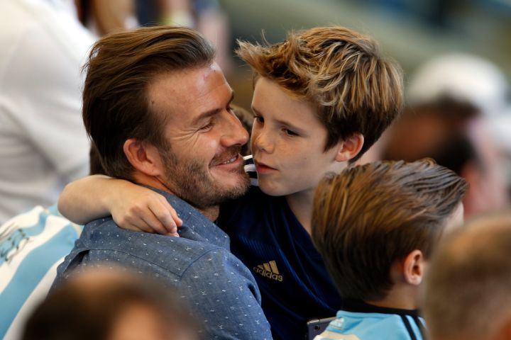 David Beckham kisses his son during the World Cup Final at Maracana stadium in Rio.