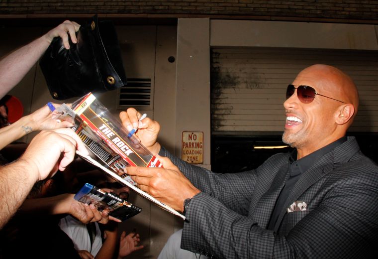 Dwayne ‘The Rock’ Johnson looks happy as a clam signing autographs at “Live with Kelly and Michael.”