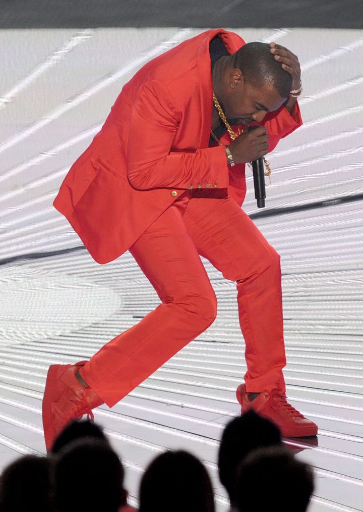 Who does red better? Kanye West in his fashionable suit…
