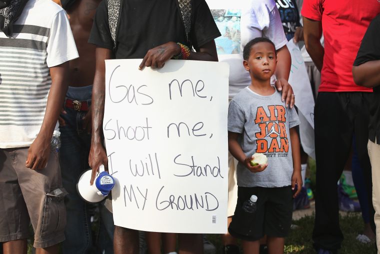 Demonstrator holds sign during a protest of the shooting of 18-year-old Mike Brown.