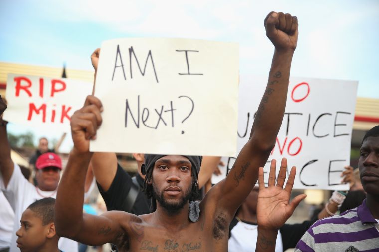 Demonstrator holds sign at protest of the Michael Brown shooting.