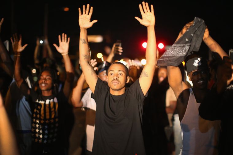 Demonstrators protest the shooting of 18-year-old Michael Brown.