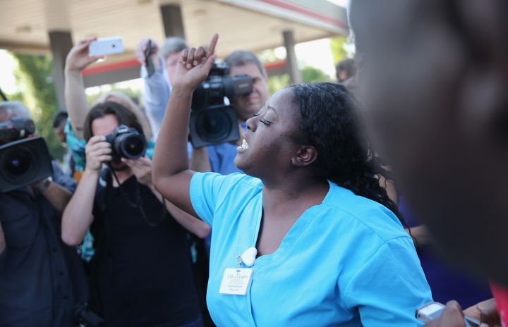 People react to the naming of the officer who shot and killed unarmed Michael Brown.