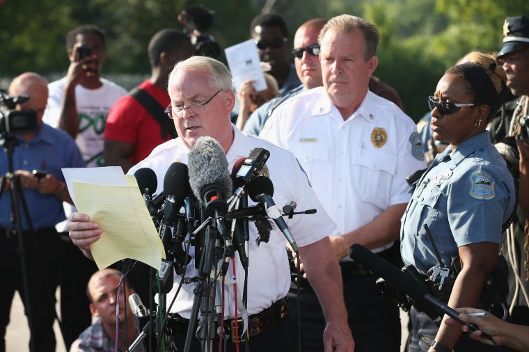 In the parking lot of a gas station, which was burned during rioting, Ferguson Police Chief Thomas Jackson announces the name of the officer who shot Michael Brown.