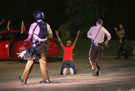 Police surround and detain two people in a car as protests reach their fourth night in a row.