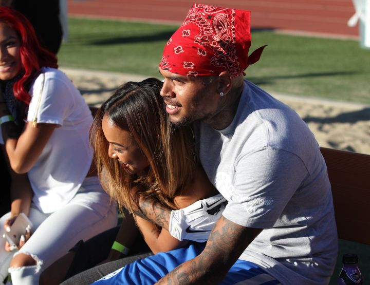 Chris Brown cuddles up to his bae Karrueche Tran as they attend his charity football game in Los Angeles, CA.