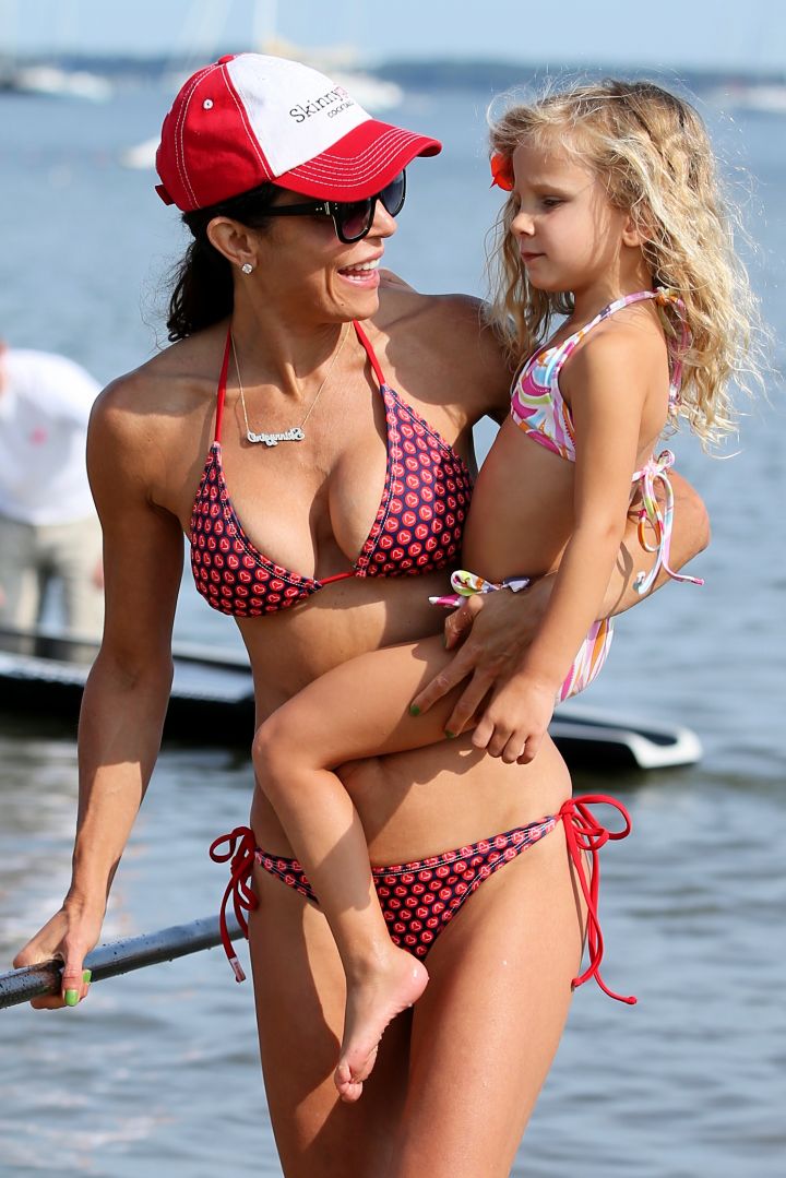 TV personality Bethenny Frankel was seen wearing a red striped bikini at the Hamptons Paddle & Pink Party with her daughter Bryn Hoppy.
