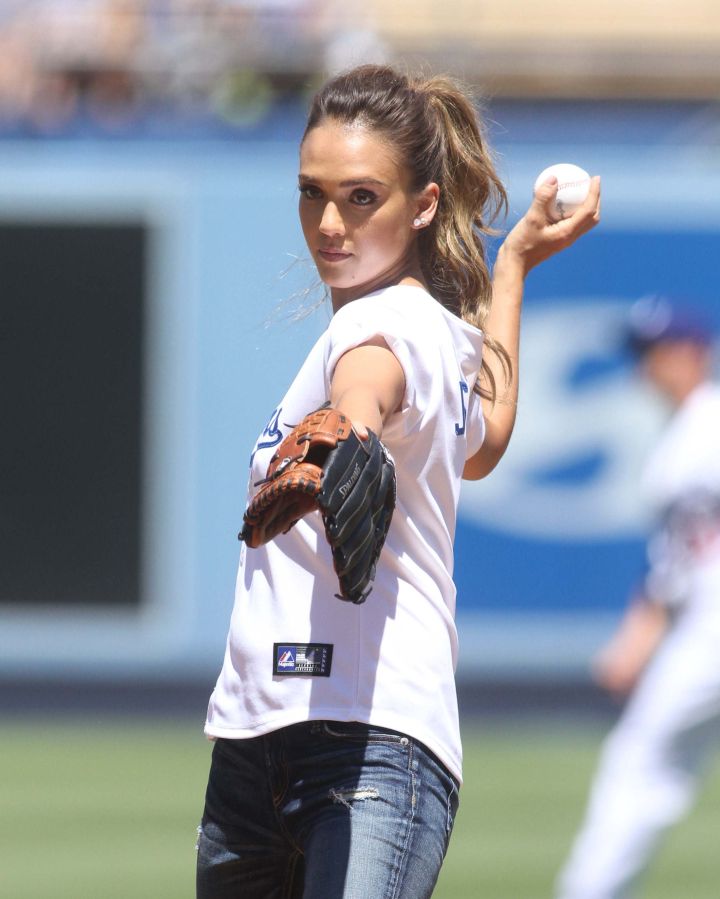 FYI: Jessica Alba proved she throws a baseball better than 50 Cent as she threw out the first pitch at Dodgers Stadium.