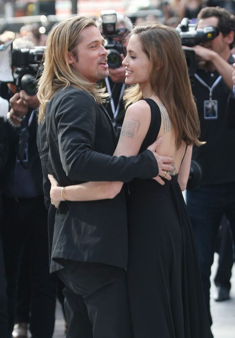 Brad holds his woman close.