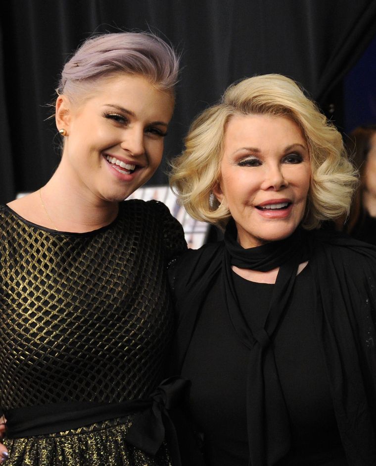Joan and her “Fashion Police” co-star Kelly Osbourne pose together backstage at Badgley Mischka’s Fall 2012 showing.