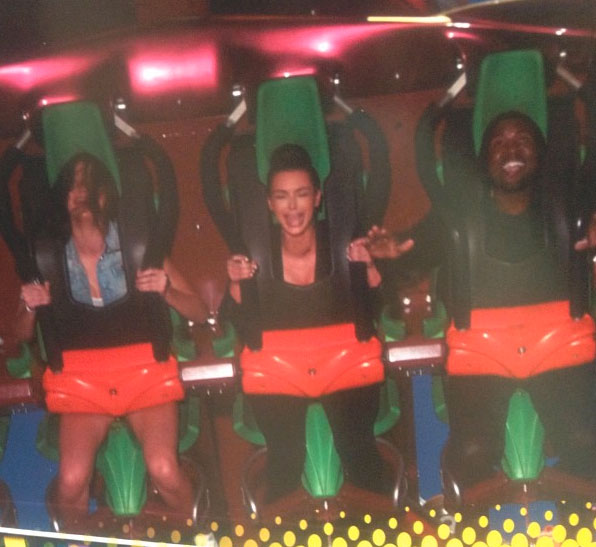 Kanye West riding a roller coaster.