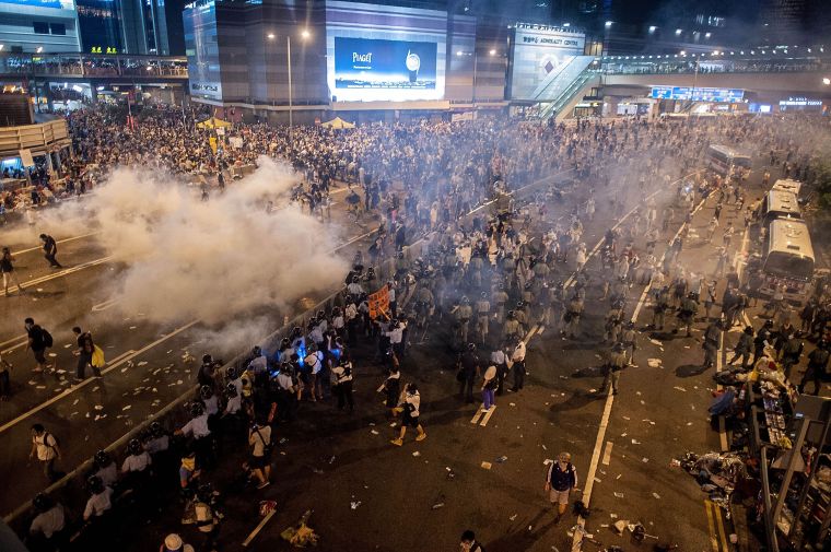 Police and demonstrators clash in the street during Hong Kong’s Umbrella Revolution, spurred by Chinese government’s plans to vet candidates in Hong Kong’s 2017 elections.