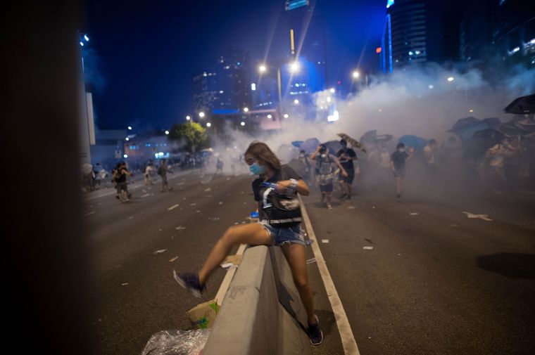 Police and demonstrators clash in the street during Hong Kong’s Umbrella Revolution, spurred by Chinese government’s plans to vet candidates in Hong Kong’s 2017 elections.