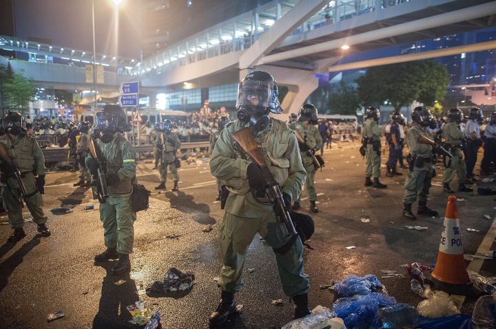 Police and demonstrators clash in the street during Hong Kong’s Umbrella Revolution, spurred by Chinese government’s plans to vet candidates in Hong Kong’s 2017 elections.