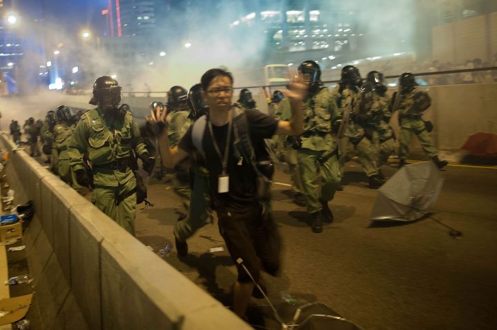 Police and demonstrators clash in the street during Hong Kong’s Umbrella Revolution, spurred by Chinese government’s plans to vet candidates in Hong Kong’s 2017 elections.